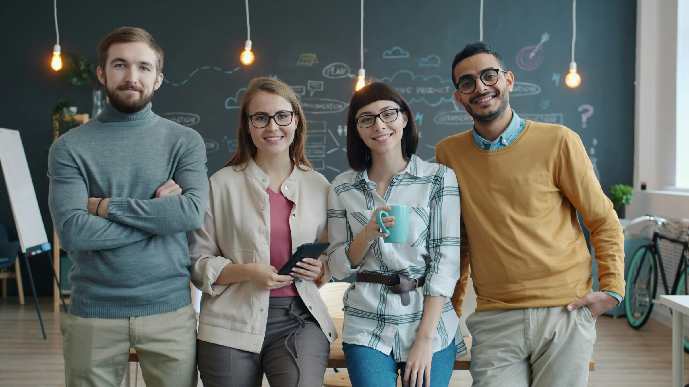 Smiling team members standing together in a bright office